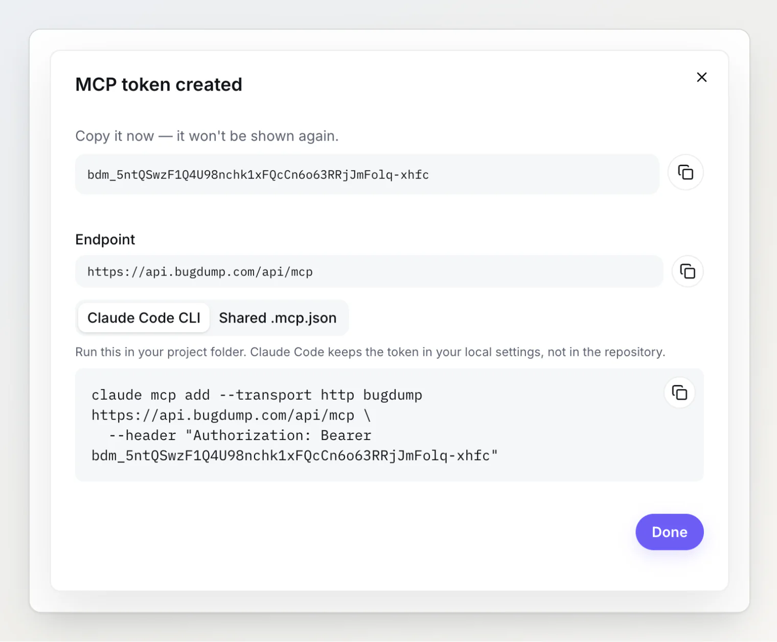 Diálogo «Token MCP criado» mostrando uma única vez o novo token bdm_, o endpoint https://api.bugdump.com/api/mcp e o comando claude mcp add